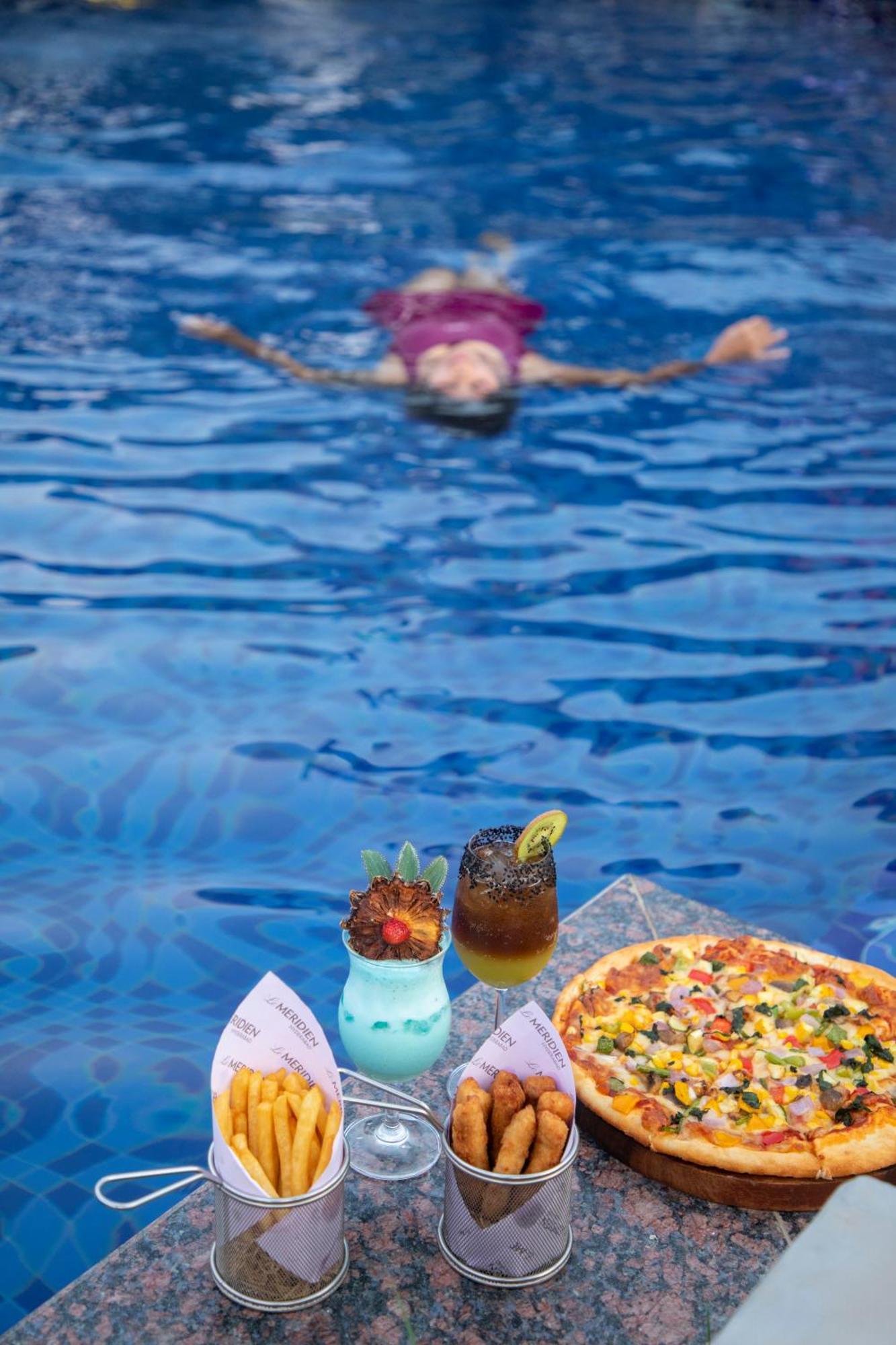 Le Meridien Hyderabad Exterior photo A woman floating in the Dead Sea
